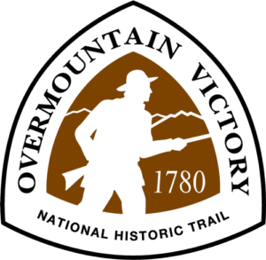 The Overmountain Victory National Historic Trail Triangle-shaped sign features the white silhouette of a militia member carrying a rifle against a brown background and the year 1780