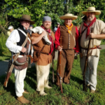 Four men in period attire pose at Arrow Rock in Missouri