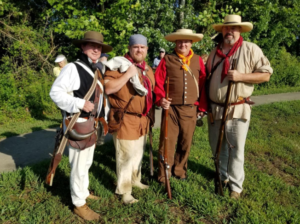 Four men in period attire pose at Arrow Rock in Missouri