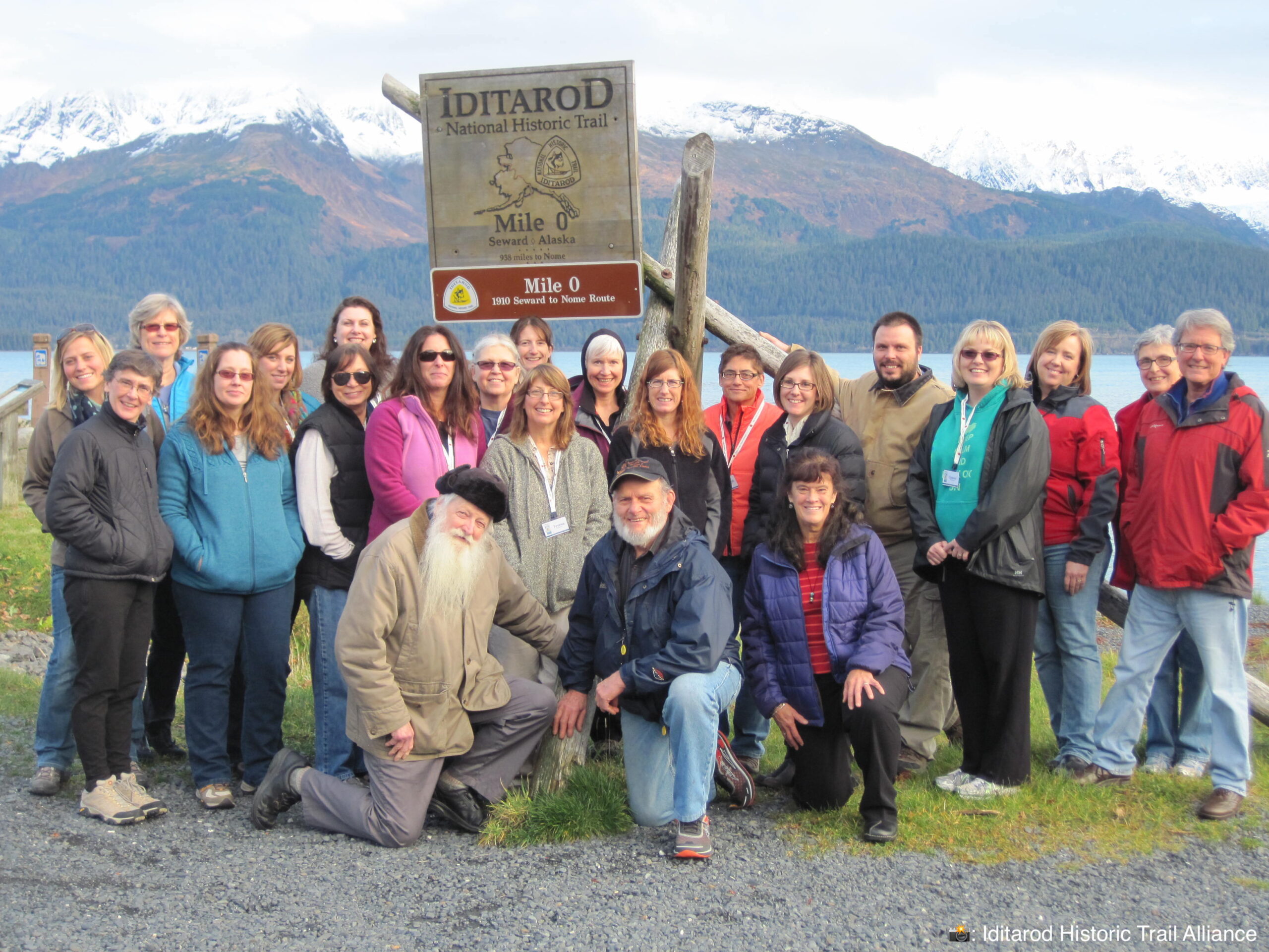 Teachers, trainers, local historians and an Iditarod dog musher stand together in Seward, Alaska at an iTREC! workshop. Mile zero of the Iditarod National Historic Trail.