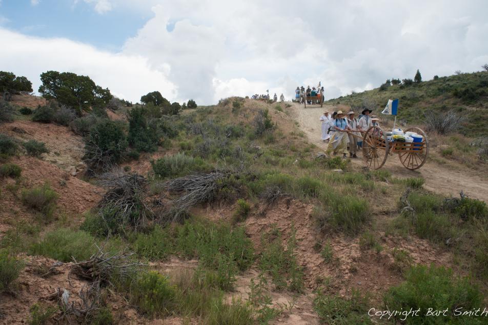Horse and carriage traveling down a trail