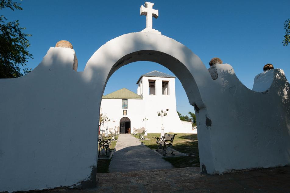 White church with an arch in front