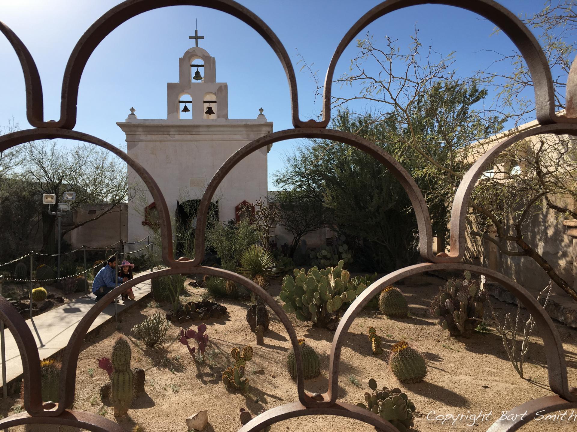 Gate framing a church in the desert